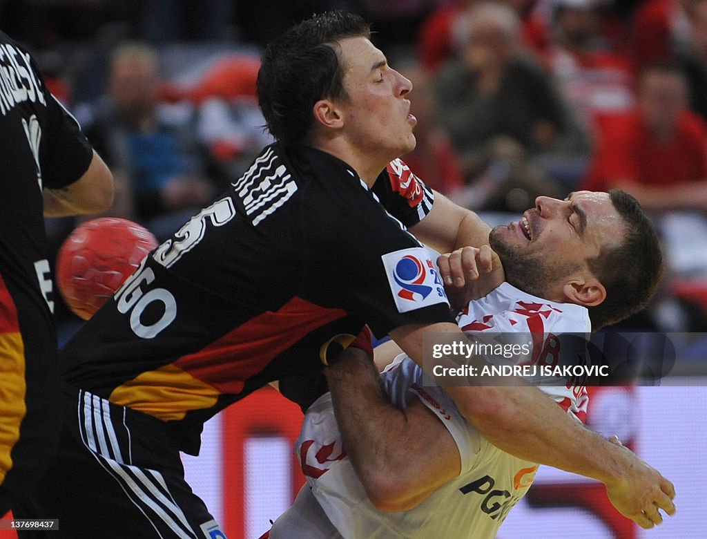 Poland's Bartosz Jurecki (R) vies with G