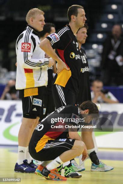 Patrick Wiencek, Pascal Hens and Uwe Gensheimer of Germany look dejcted after losing 32-33 the Men's European Handball Championship second round...