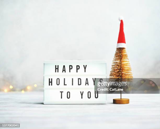 christmas arrangement with tinsel christmas tree and happy holidays message - happy holidays stock pictures, royalty-free photos & images
