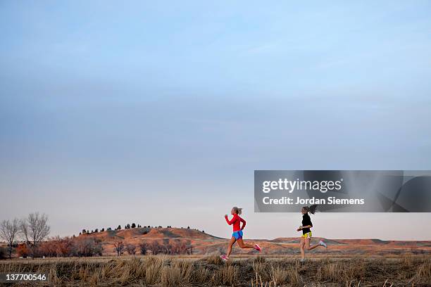 two females running together. - billings stockfoto's en -beelden