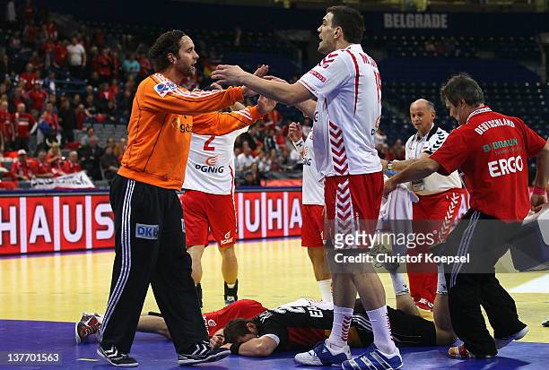Silvio Heinevetter of Gemrany discusses with Michal Jurecki of Poland after the injury of Michael Haass of Germany and Krzysztof Lijewski of Poland...