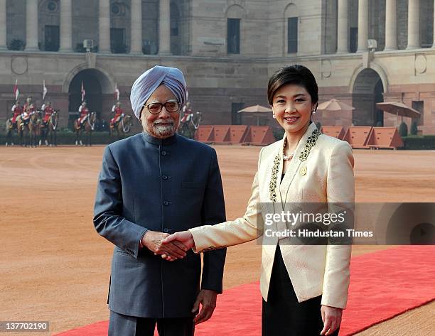 Thai Prime Minister Yingluck Shinawatra shakes hands with Prime Minister Manmohan Singh during her ceremonial reception at President House on January...