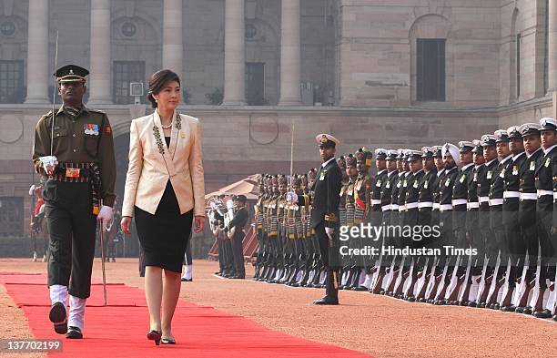 Thai Prime Minister Yingluck Shinawatra inspects a guard of honor during her ceremonial reception at President House on January 25, 2012 in New...