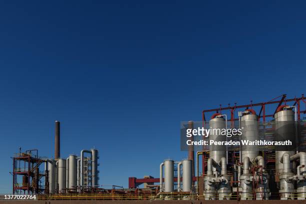 metal refinery tank, red painted structure and steel pipelines. - rust deutschland stock-fotos und bilder