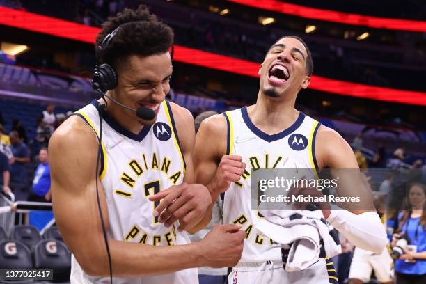 Tyrese Haliburton of the Indiana Pacers celebrates with Malcolm Brogdon after defeating the Orlando Magic 122-114 in overtime at Amway Center on...