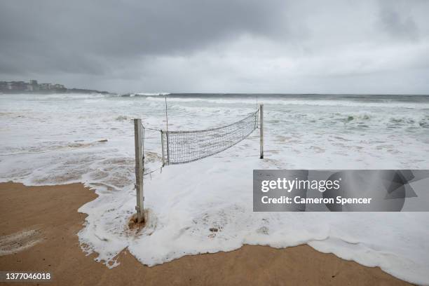 Beach volleyball courts are submerged by the ocean at Manly Beach as large swell hits the beach at high tide as a major low pressure system impacts...