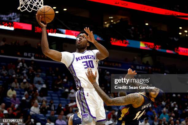 Damian Jones of the Sacramento Kings shoots over Brandon Ingram of the New Orleans Pelicans during the third quarter of an NBA game at Smoothie King...