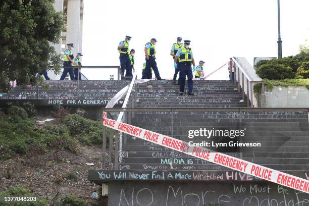 Police officers on the graffiti covered steps to the Beehive inside the cordoned off area of Wellington city around Parliament buildings as the clean...