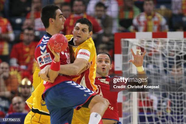 Velko Markoski of Macedonia defends against Zarko Sesum of Serbia during the Men's European Handball Championship second round group one match...