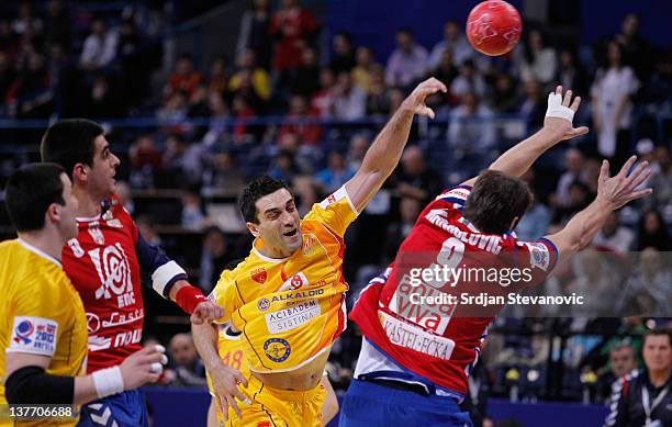 Serbia Kiril Lazarov of Macedonia shoots the ball past Nikola Manojlovic and Zarko Sesum of Serbia during the Men's European Handball Championship...