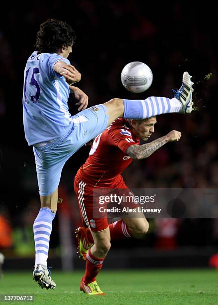 Stefan Savic of Manchester City competes with Craig Bellamy of Liverpool during the Carling Cup Semi Final Second Leg match between Liverpool and...