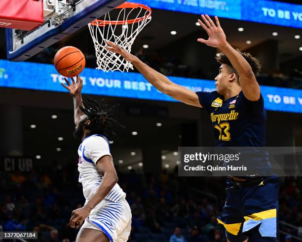 Javon Freeman-Liberty of the DePaul Blue Demons shoots a reverse lay up in the second half against Oso Ighodaro of the Marquette Golden Eagles at...