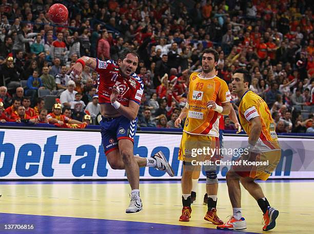 Alem Toskic of Serbia scores a goal against Filip Mirkulovski and Bransilav Angelovski of Macedonia during the Men's European Handball Championship...