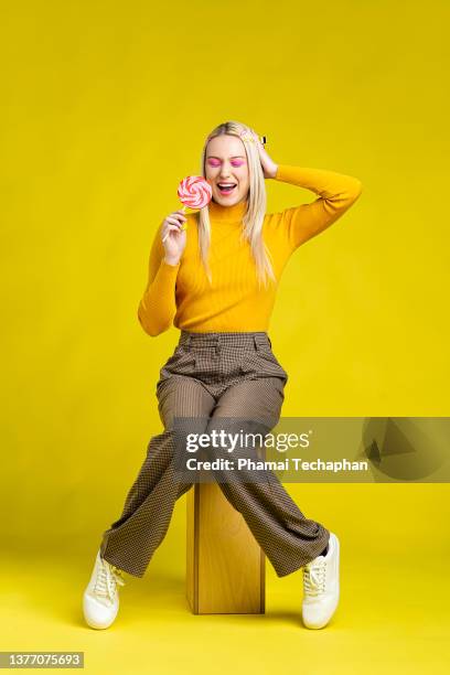 woman holding a large lollipop - lolly models stockfoto's en -beelden