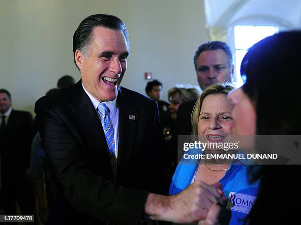 Republican presidential hopeful Mitt Romney greets supporters as he participates in a "US-Cuba Democracy PAC Event" at Freedom Tower at Miami-Dade...