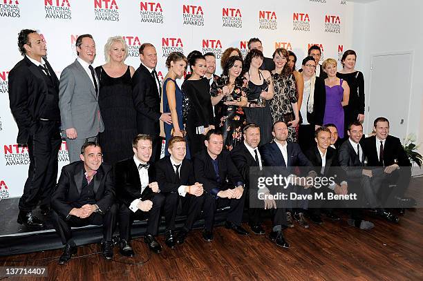 The cast and crew of Coronation Street pose in front of the winners boards after winning the Serial Drama Award during the National Television Awards...