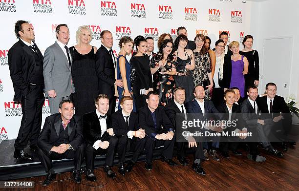 The cast and crew of Coronation Street pose in front of the winners boards after winning the Serial Drama Award during the National Television Awards...