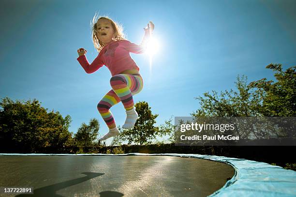 jumping girl - trampoline jump stock-fotos und bilder