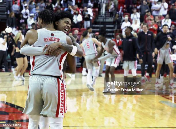 Bryce Hamilton and Keshon Gilbert of the UNLV Rebels celebrate on the court after defeating the Wyoming Cowboys 64-57 at the Thomas & Mack Center on...