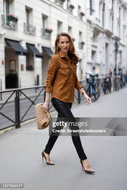 Influencer Alexandra Lapp wearing a light brown "u2018Mari"u2019 suede shirt by Bigardini, black leather stretch leggings by Bigardini, gold City...