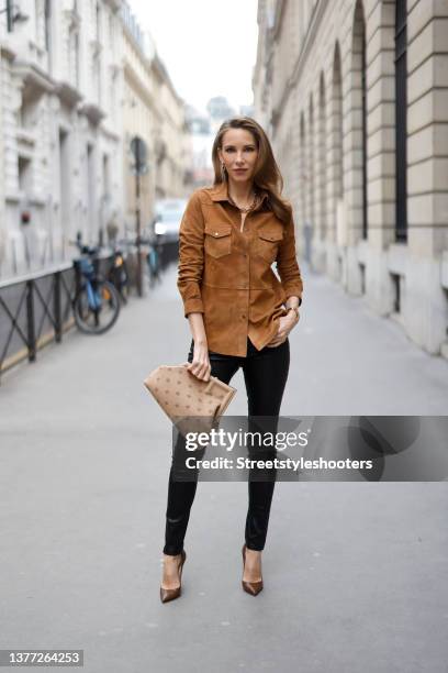 Influencer Alexandra Lapp wearing a light brown "u2018Mari"u2019 suede shirt by Bigardini, black leather stretch leggings by Bigardini, gold City...