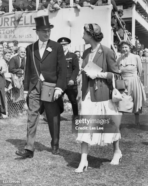 Queen Elizabeth II with racehorse owner Sir Humphrey de Trafford on Ladies' Day at Epsom Downs Racecourse, Surrey, 4th June 1954.