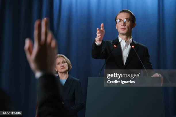white young american politician listening to the questions after the debates - eerste minister stockfoto's en -beelden