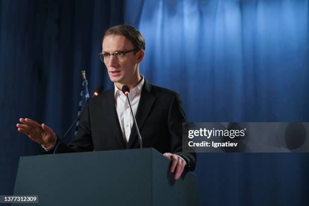 white young american politician explaining something at the debates - president podium stock pictures, royalty-free photos & images