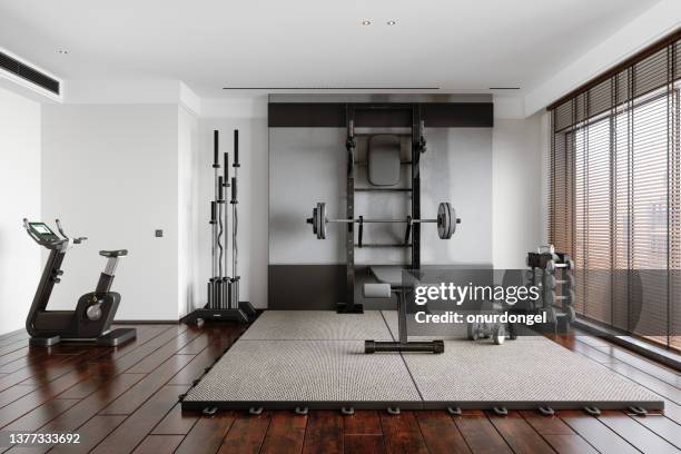 personal training studio with barbell, dumbbells, exercise bike and other sports equipments - weight bench stock pictures, royalty-free photos & images
