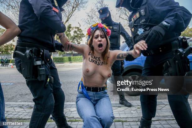 Several agents expel a Femen woman during a protest in front of the Russian embassy in Spain, March 3 in Madrid, Spain. With this action, Femen wants...
