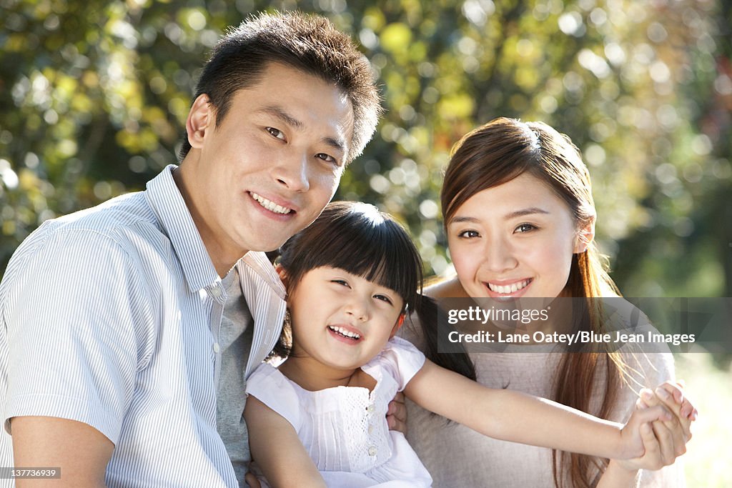 Young family portrait outdoors