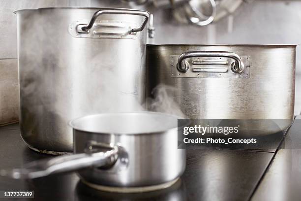 pots boiling on stove - pots and pans stock pictures, royalty-free photos & images