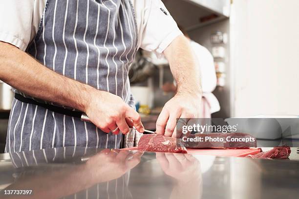 chef slicing meat in kitchen - action cooking stock pictures, royalty-free photos & images