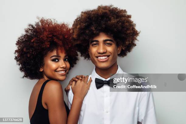 happy brother and sister with afro hairstyle - teen sibling stock pictures, royalty-free photos & images