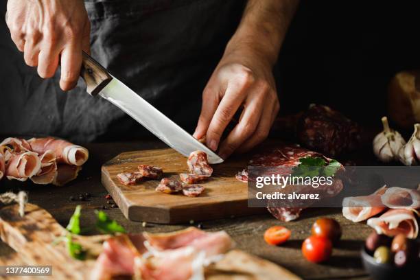 close-up of a woman preparing cheese and meat platter - ham salami bildbanksfoton och bilder