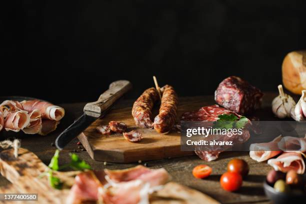 preparation of cheese and meat platter - different cuts of meat stock pictures, royalty-free photos & images