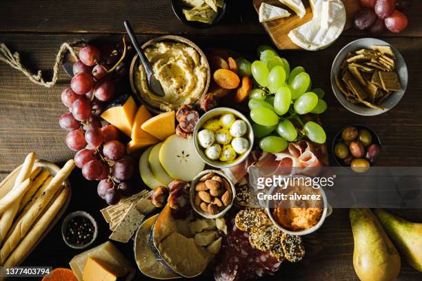delicious appetizer on rustic wooden table - appetizers stock pictures, royalty-free photos & images