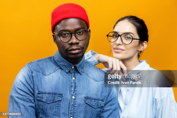 portrait of a diverse fashion models posing for a photo shoot in a professional studio - fashion model couple stock pictures, royalty-free photos & images