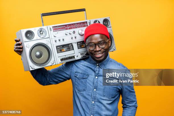 portrait of a handsome african american male model posing in a professional studio - ghetto blaster stock pictures, royalty-free photos & images