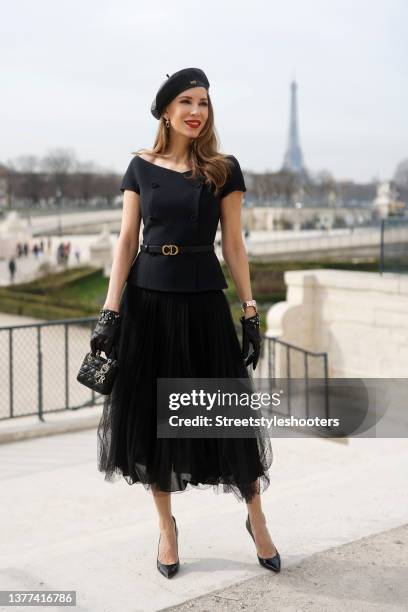 Influencer Alexandra Lapp wearing a black tulle flared mid-length skirt by Dior, a black double breasted vest by Dior, a black Mini Lady Dior bag by...