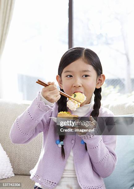 girl eating sushi - holding chopsticks stock pictures, royalty-free photos & images