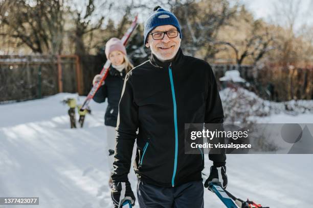 father and daughter spending the day together - man skiing stock pictures, royalty-free photos & images