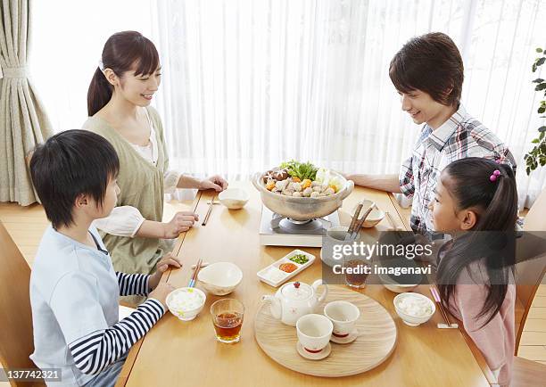 parents and kids sitting around japanese hot pot - japanese girls hot fotografías e imágenes de stock