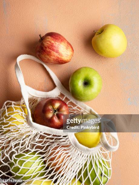 apples, ripe apples in shopping bag on background, apples on the colored background. ripe different apples - reusable bag isolated stock pictures, royalty-free photos & images