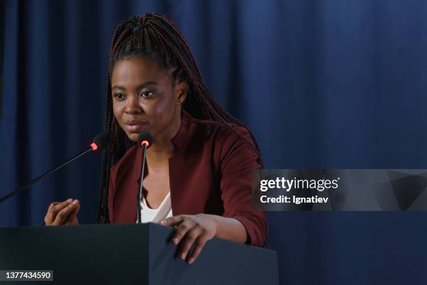 young emotional american politician in close up against the dark blue curtain - ambassador bildbanksfoton och bilder