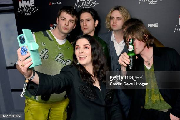 Aisling Bea, Tom Coll, Grian Chatten, Carlos O'Connell, Conor Deegan and Conor Curley of Fontaines D.C in the Winners Room during the NME Awards 2022...