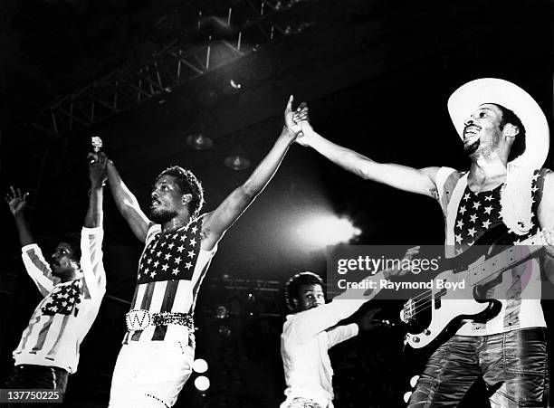 Singers and musicians Ronnie, Charlie and Robert Wilson of The Gap Band prepares to take a bow after their performance at the U.I.C. Pavilion in...