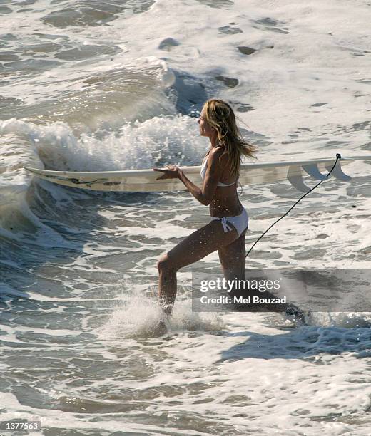 Actress Cameron Diaz prepares to surf on the set of her upcoming movie, "Charlie's Angels 2" on September 10, 2002 in Malibu, California.