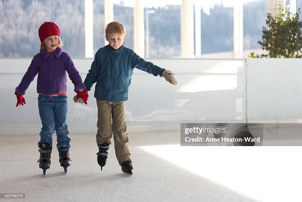 Two boys enjoy ice skating