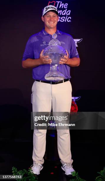 Sepp Straka of Austria poseswith the trophy during a press conference after putting in to win on the 18th green during the final round of The Honda...